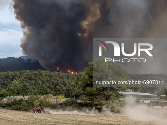 Firefighters and volunteers are working to stop the wildfire in the counties of Anoia and Conca de Barberà, near Barcelona on July 25 and 26...