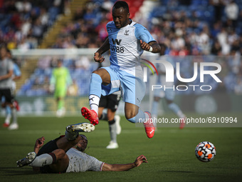  Akin Famewo clears the ball ahead of an on running Jordan Ayew during the Pre-season Friendly match between Crystal Palace and Charlton Ath...