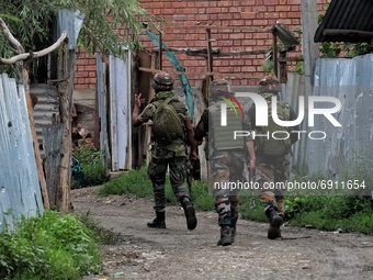 Indian Army Soldiers walk during a Cordon and Search Operation after suspected militants on Wednesday hurled a grenade towards police party...