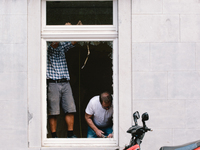 people repair their house window in Stolberg, Germany on July 28, 2021 (