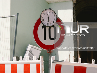 a clock is seen stopped on top pf a traffic speed sign in Stolberg, Germany on July 28, 2021 (