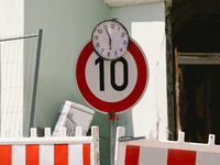a clock is seen stopped on top pf a traffic speed sign in Stolberg, Germany on July 28, 2021 (