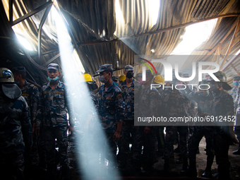 Nepalese police inspect the site after extinguishing a fire in a local furniture company in Kathmandu, Nepal on  July 28, 2021.  (