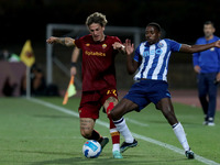 Nicolo Zaniolo of AS Roma (L) vies with Wilson Manafa of FC Porto during an international club friendly football match between AS Roma and F...