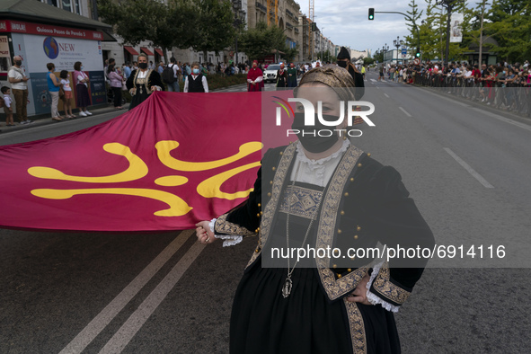 Some young women carry the flag with a Labaro, the traditional flag of Cantabria (although it is not official) during the Parade with typica...
