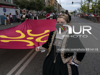 Some young women carry the flag with a Labaro, the traditional flag of Cantabria (although it is not official) during the Parade with typica...