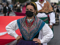 A woman dressed in a typical regional costume of Cantabria, parades through the streets of Santander to commemorate the Day of Institutions,...