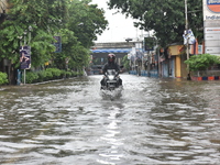A motorcyclist is seen waded through a waterlogged street in Kolkata, India, on July 30, 2021. (