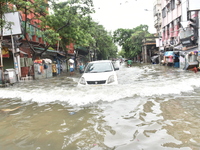 A taxi is seen waded through a waterlogged street in Kolkata, India, on July 30, 2021. (