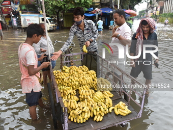 A boy sells fruits in the water logged street in Kolkata, India, on July 30, 2021. (