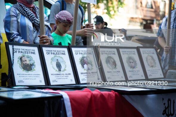 Pictures of victims are displayed as people demonstrate in support of Palestine in Brooklyn, New York, US on July 31, 2021.  