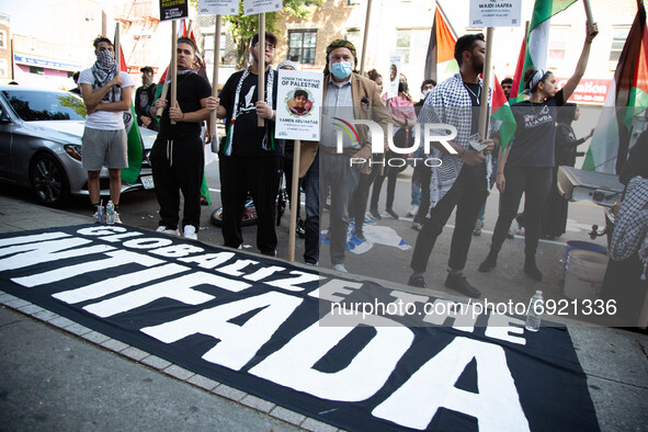 A sign reading ''Globalize The Intifada'' is seen on the ground as people demonstrate in support of Palestine in Brooklyn, New York, US, on...