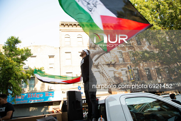 A man carries a palestinian flag as people demonstrate in support of Palestine in Brooklyn, New York, US on July 31, 2021.  