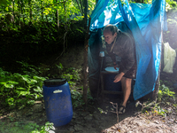 Environmental  activists change toilet barrels in their occupational camp in Turnicki forest on July 28, 2021 near Arlamow, Carpathian mount...