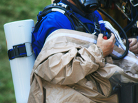 Hazardous materials emergency response worker suits-up while responding to a call to clean up a dangerous chemical spill in Toronto, Ontario...