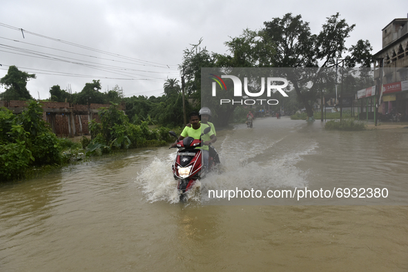 A scooty wades through a flooded street of Udaynarayanpur, Howrah district of West Bengal, India, 04 August, 2021.  