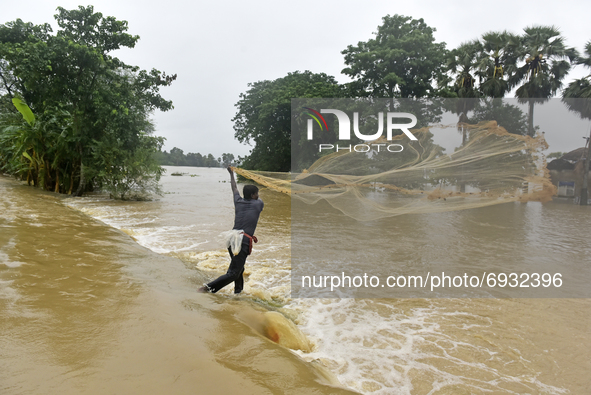 A villager catch fish during massive flood in Udaynarayanpur, Howrah district of West Bengal, India, 04 August, 2021.  