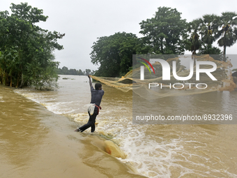 A villager catch fish during massive flood in Udaynarayanpur, Howrah district of West Bengal, India, 04 August, 2021.  (