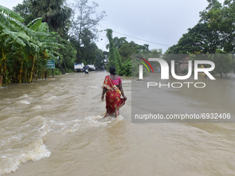 A woman wades through a flooded street in Udaynarayanpur, Howrah district of West Bengal, India, 04 August, 2021.   (