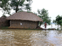 A villeger strand  a waterlogged  his home compound and wating reloef in the flood hit city of Amta-2 in the Howrah district about 82 kms fr...