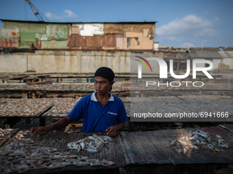 A man dries fish at a fishermen village in the North of Indonesia capital Jakarta on 8 August 2021. According to the data from the Central B...