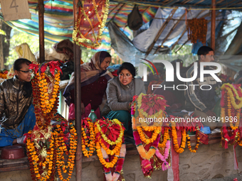 Merchants selling flowers, garlands and offerings for the Goddess Kali as well as buffalo milk yoghurt and Khuwa (a condensed milk sweet) on...