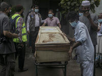  Forensic doctors   take out the coffins  with the remains  who died in the deadly fire that had engulfed a Narayanganj factory last month....