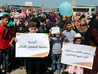 Palestinian children release balloons during a protest against the blockade on Gaza at the port of Gaza City on August 10 , 2021.  (