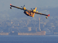 a Canadair engaged in fighting the fires in Sicily flies over the waters of the Strait of Messina to supply water. Messina(Sicily), August 1...