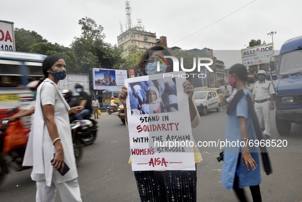 Activists shout slogans, carry placards against the alleged incursion of Taliban forces in Afganistan country where woman feel insecure, Kol...