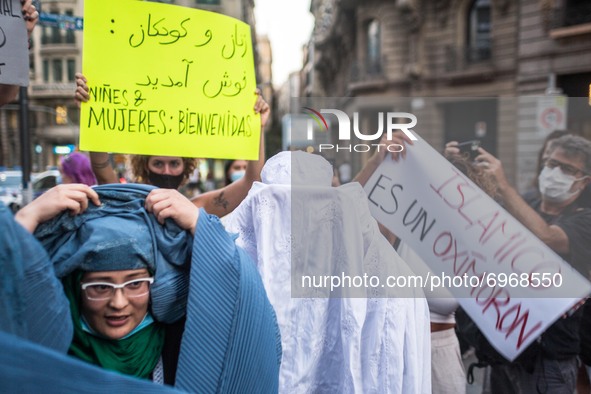Protesters are seen taking off their burqa.
Around a hundred women have participated in a feminist demonstration in front of the United Nati...