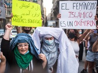 Protesters are seen taking off their burqa.Around a hundred women have participated in a feminist demonstration in front of the United Nati...