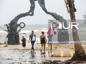 Tourists walking on the beach  after Category 1 Hurricane 'Grace' hit Playa del Carmen in the Mexican Caribbean. On August 19, 2021 in Playa...