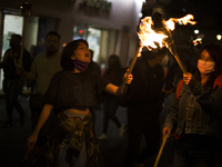 Members of the Aspirants Excluded from Higher Education Movement (MAES for its acronym in Spanish) marched with torches to demand that their...