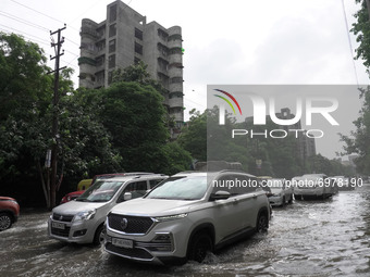 Vehicles move past a flooded street after heavy rains in Ghaziabad, a suburb of New Delhi, India on August 21, 2021.  Intense rains lashed t...