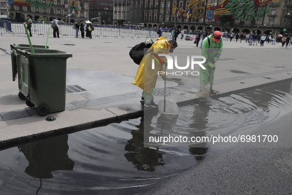 Clean-up workers unclog drains in the Historic Centre of Mexico City after heavy rains and strong gusts of wind due to Hurricane Grace, whic...