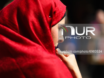 A woman wearing hijab attends protest In Solidarity With Afghanistan in front of the U.S. Consulate General in Krakow, Poland on August 22,...