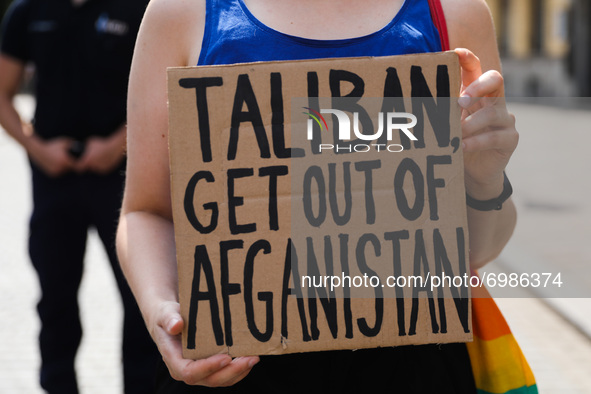 A demonstrator holds a banner 'Taliban Get Out Of Afganistan' during a protest In Solidarity With Afghanistan in front of the U.S. Consulate...