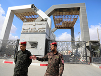 Members of Palestinan security forces stand guard at the closed off Rafah border crossing to Egypt in the southern Gaza Strip, on August 23,...