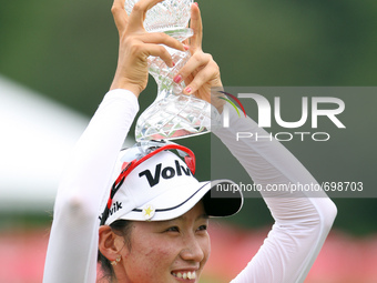 Chella Choi of South Korea holds up the trophy during the award ceremony after winning the tournament in the final round of the Marathon LPG...
