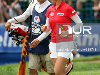 Chella Choi of Seoul, South Korea and her father and caddy Ji Yeon Choi rush to their cart to head back to the 18th tee from the 18th green...