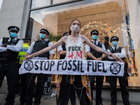 LONDON, UNITED KINGDOM - AUGUST 24, 2021: An environmental activist from Extinction Rebellion protests outside Selfridges department store i...