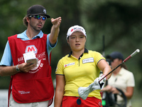 Ha-Na Jang of Seoul, South Korea looks down the fairway with her caddy at the 13th tee in the final round of the Marathon LPGA Classic golf...