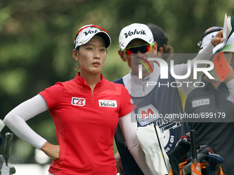 Chella Choi of Seoul, South Korea looks down the fairway at the 13th tee with her father and caddy Ji Yeon Choi in the final round of the Ma...
