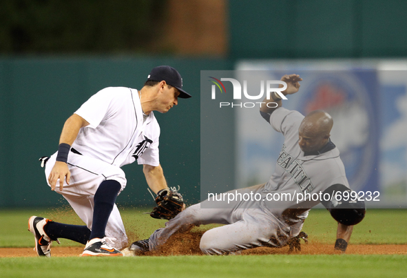 Seattle Mariners' Austin Jackson beats the tag of Detroit Tigers second baseman Ian Kinsler, left, to steal second base in the sixth inning...