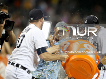 Detroit Tigers pitcher Alex Wilson showers Ian Kinsler with the Gatorade cooler after Kinsler's wining second two-run home run of the game a...