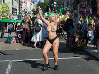 LONDON, UNITED KINGDOM - AUGUST 25, 2021: A topless environmental activists from Extinction Rebellion demonstrates on Oxford Street on the t...