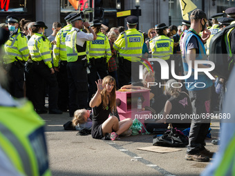 LONDON, UNITED KINGDOM - AUGUST 25, 2021: Environmental activists from Extinction Rebellion are locked-on in Oxford Circus on the third day...