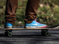 A person wearing Nike shoes is seen skateboarding in the park Krakow, Poland on March 31, 2021. (