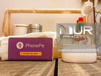 A PhonePe symbol is seen inside a restaurant in Kolkata , India , on 27 August 2021 . Walmart own PhonePe , a UPI based digital wallet and m...